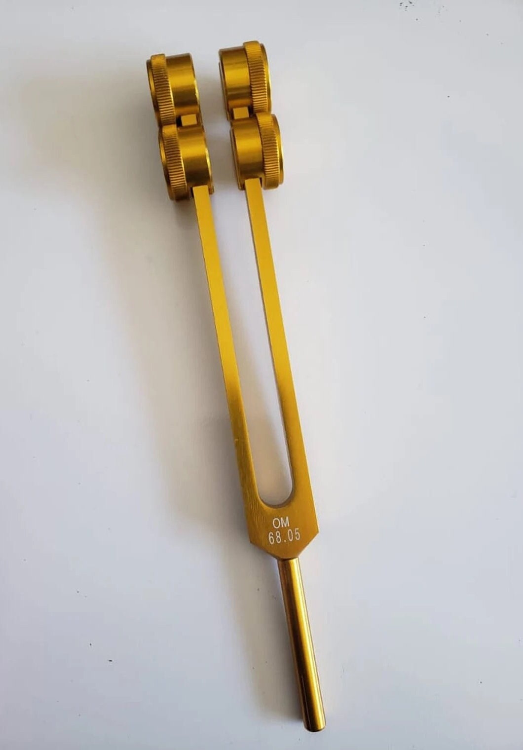 Low Om 68.05 9th Chakra Hz Weighted Tuning Fork with Velvet Bag - Thecosmicaccess