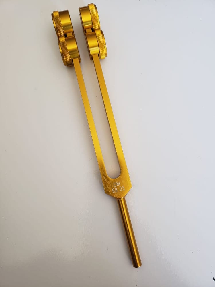 Low Om 68.05 Gold Color 9th Chakra Hz Weighted Tuning Fork with Mallet and Velvet Bag - Thecosmicaccess