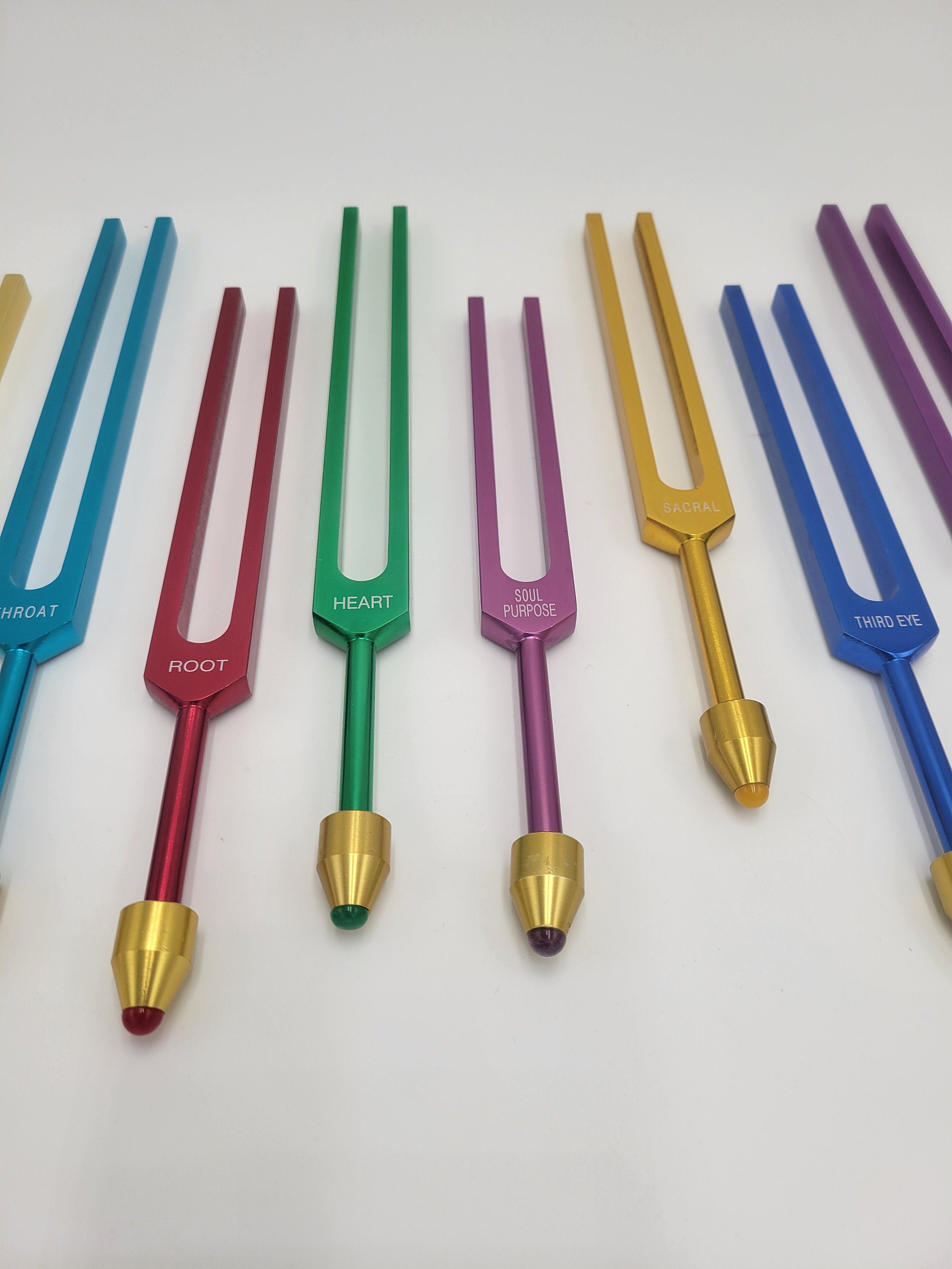 The Holistic Chakra Color Unweighted Tuning Fork Set with 8 GEM FEET on each Fork with 8 Mallets and Chakra Marked Drawstring Pouches - Thecosmicaccess