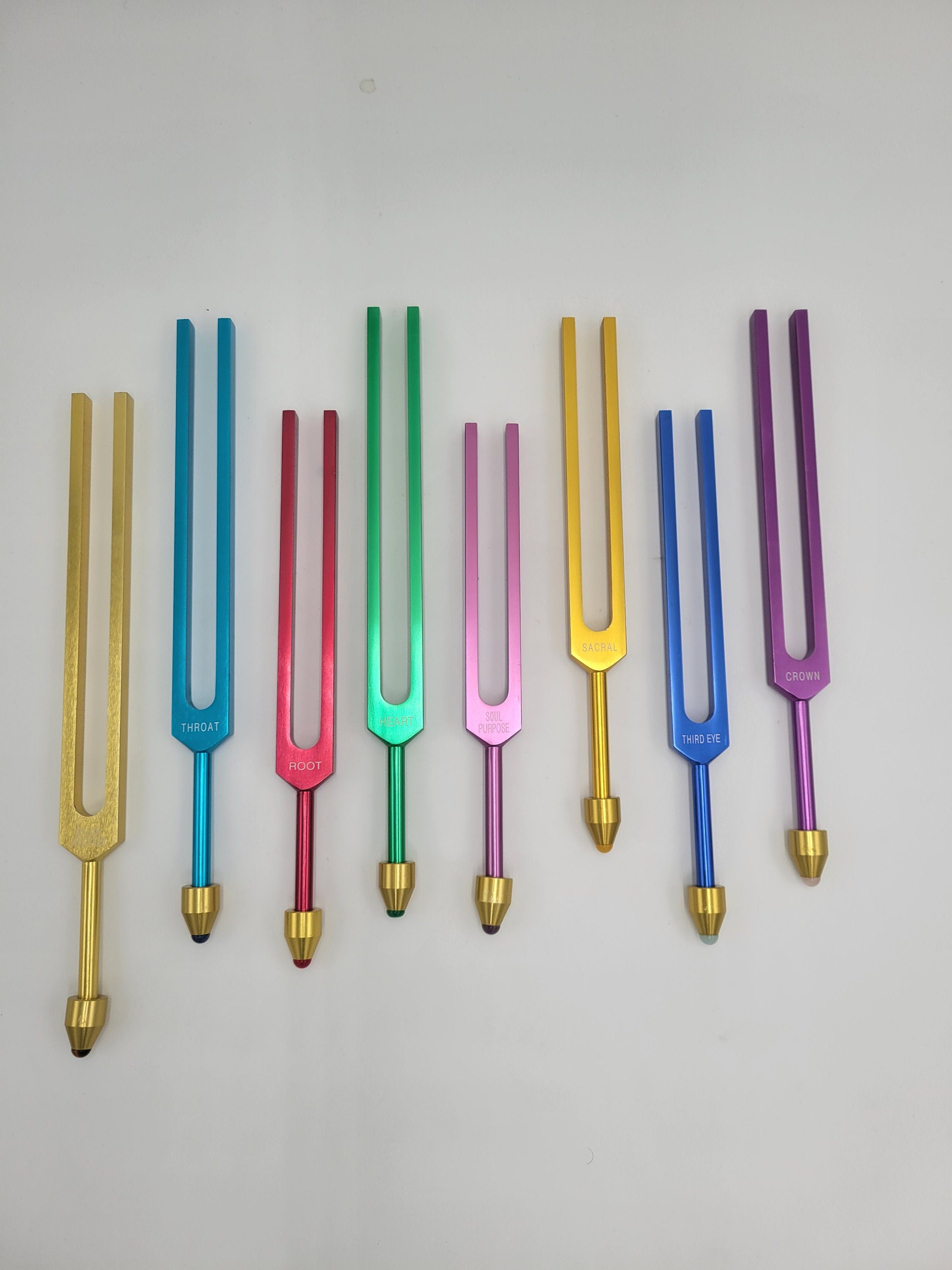 The Holistic Chakra Color Unweighted Tuning Fork Set with 8 GEM FEET on each Fork with 8 Mallets and Chakra Marked Drawstring Pouches - Thecosmicaccess