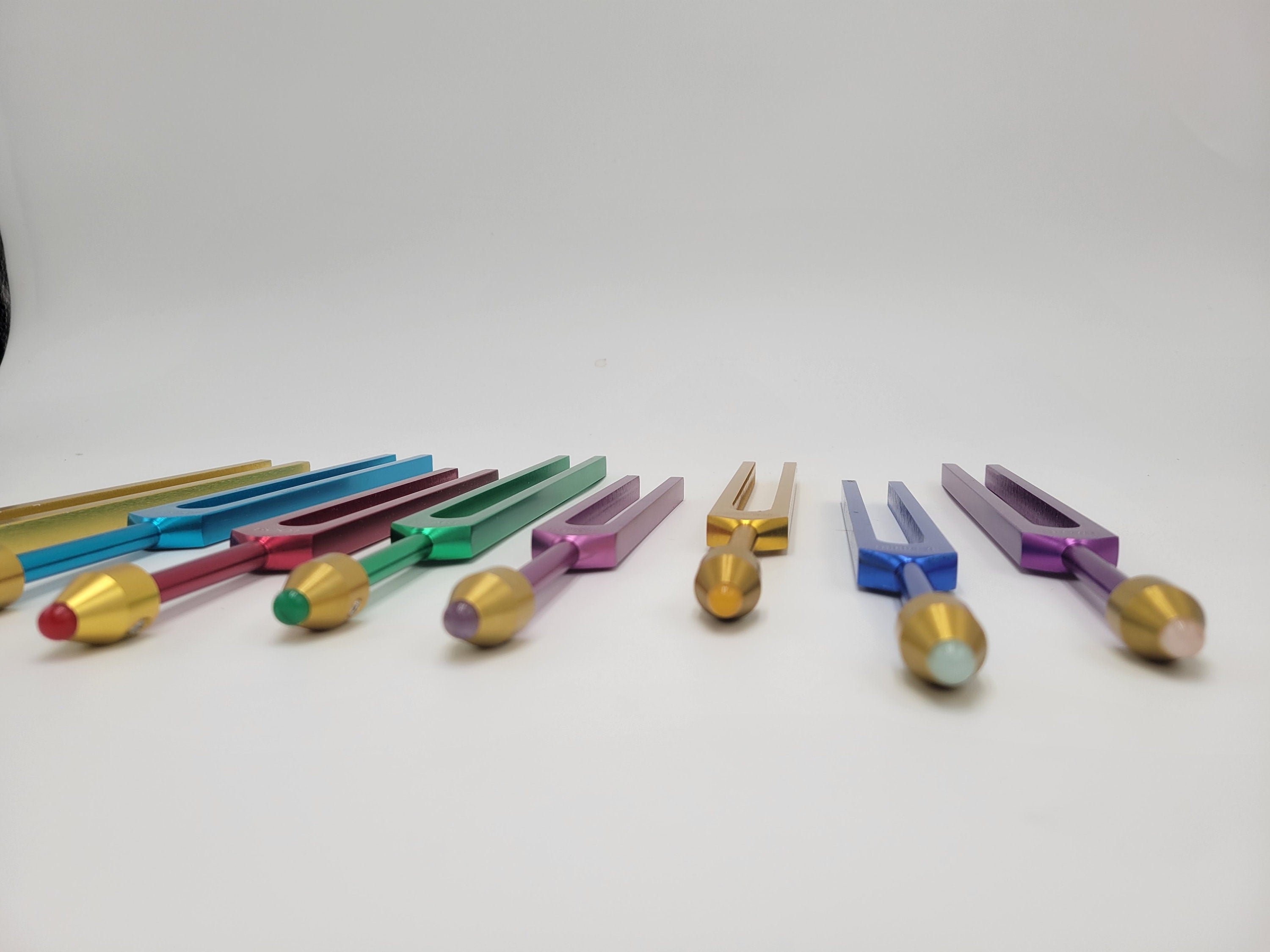 The Holistic Chakra Color Unweighted Tuning Fork Set with 8 GEM FEET on each Fork with 8 Mallets and Chakra Marked Drawstring Pouches - Thecosmicaccess