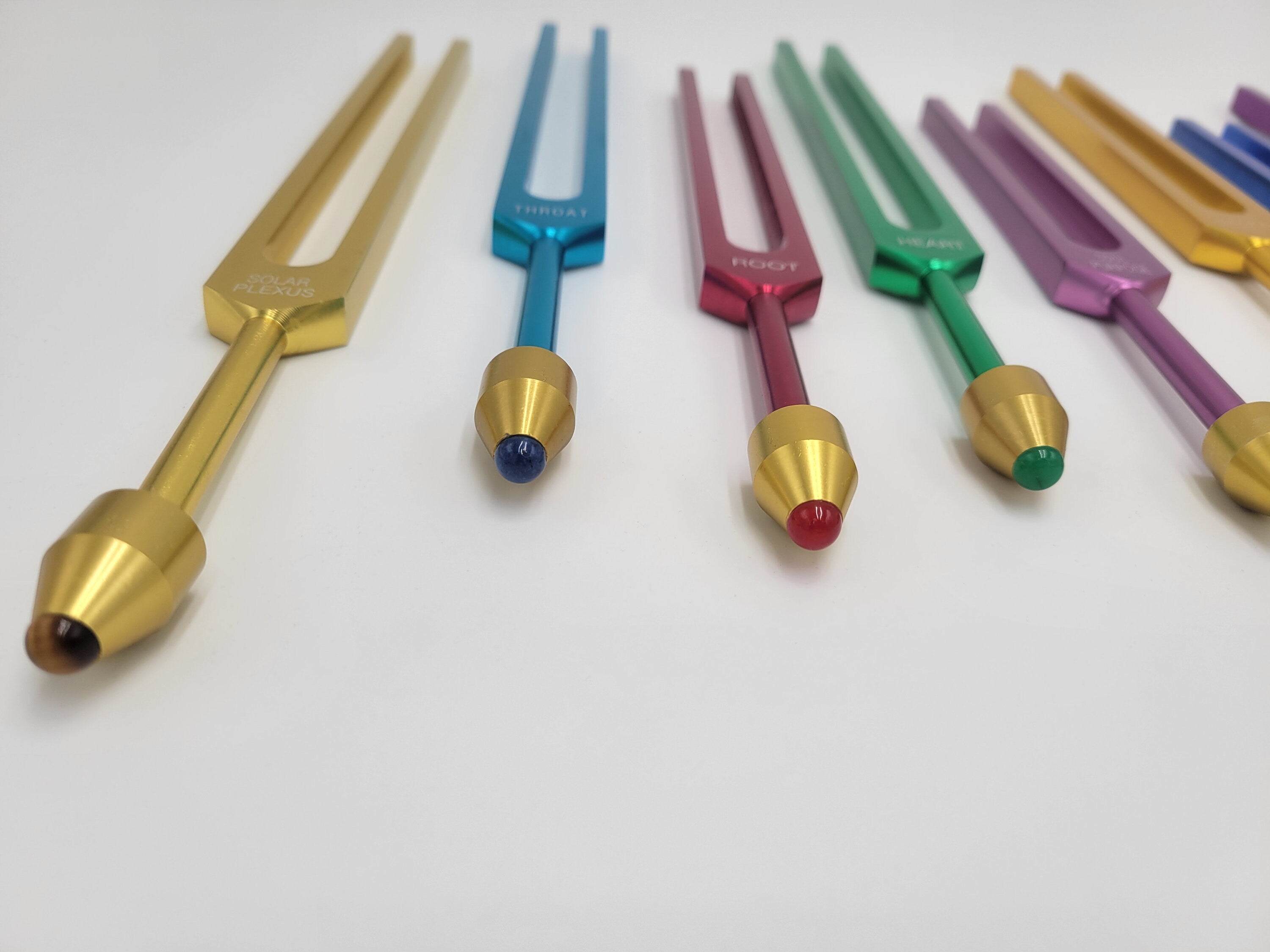 The Holistic Chakra Color Unweighted Tuning Fork Set with 8 GEM FEET on each Fork with 8 Mallets and Chakra Marked Drawstring Pouches - Thecosmicaccess