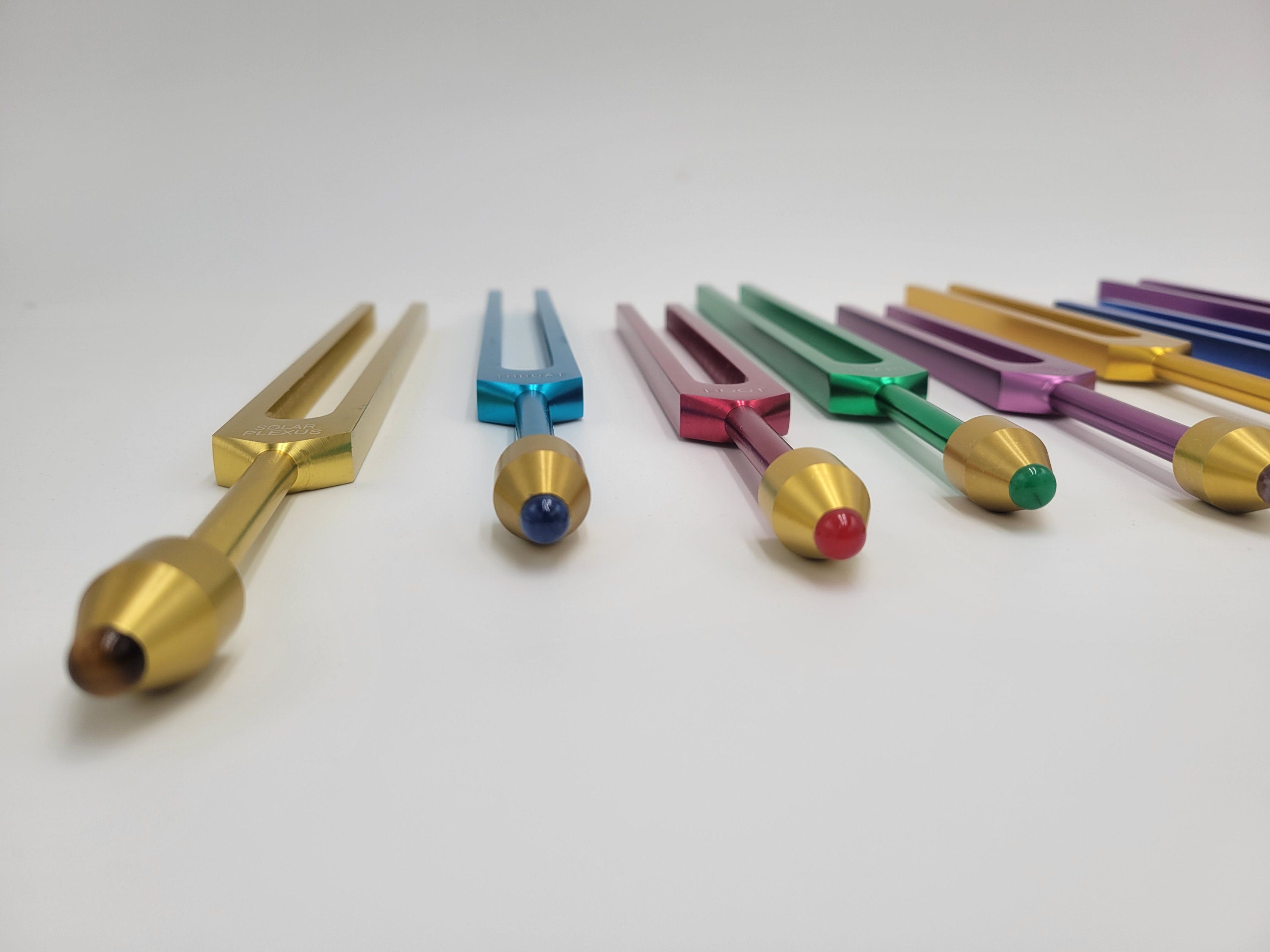 The Holistic Chakra Color Unweighted Tuning Fork Set with 8 GEM FEET on each Fork with 8 Mallets and Chakra Marked Drawstring Pouches - Thecosmicaccess