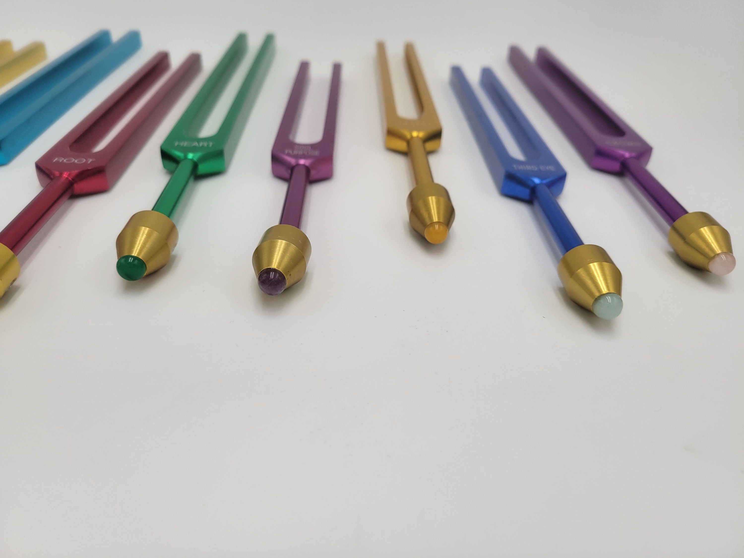 The Holistic Chakra Color Unweighted Tuning Fork Set with 8 GEM FEET on each Fork with 8 Mallets and Chakra Marked Drawstring Pouches - Thecosmicaccess