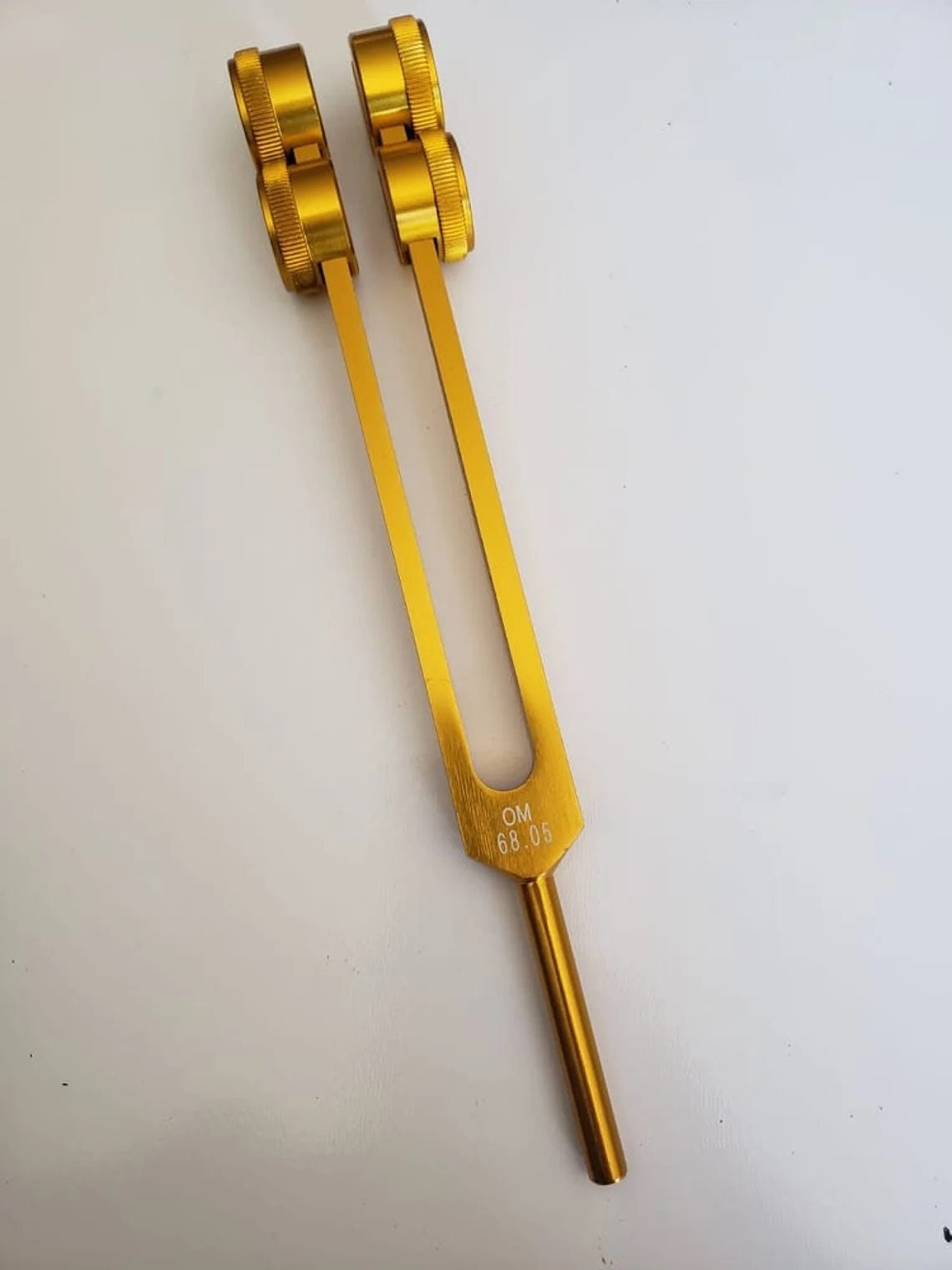 Low Om 68.05 9th Chakra Hz Weighted Tuning Fork with Velvet Bag - Thecosmicaccess